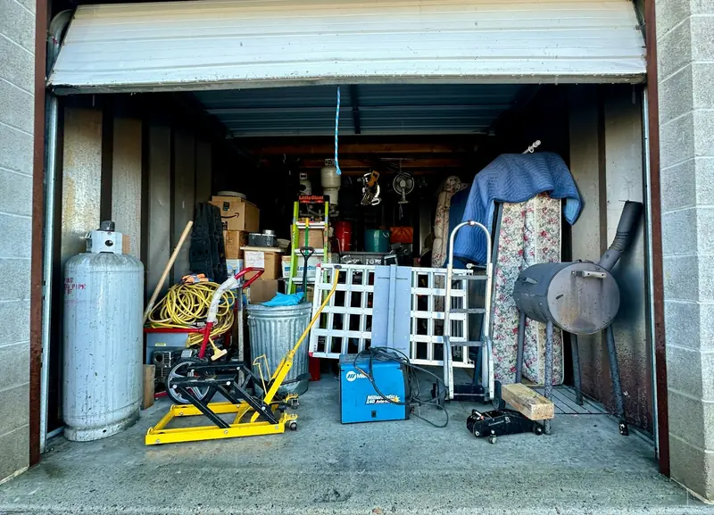 Cluttered storage unit before a junk removal job